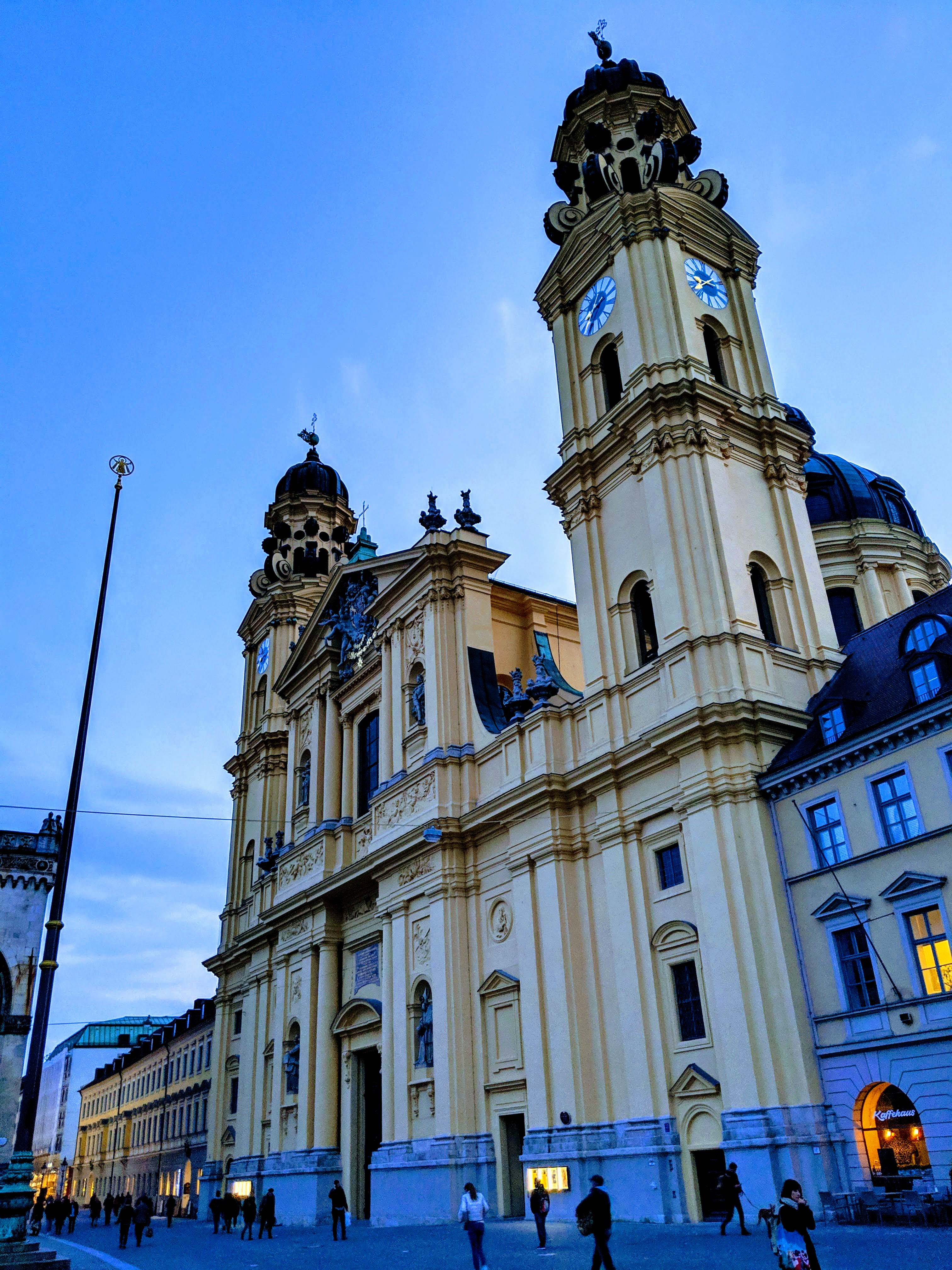 Baroque church towers against a twilight blue sky in Munich