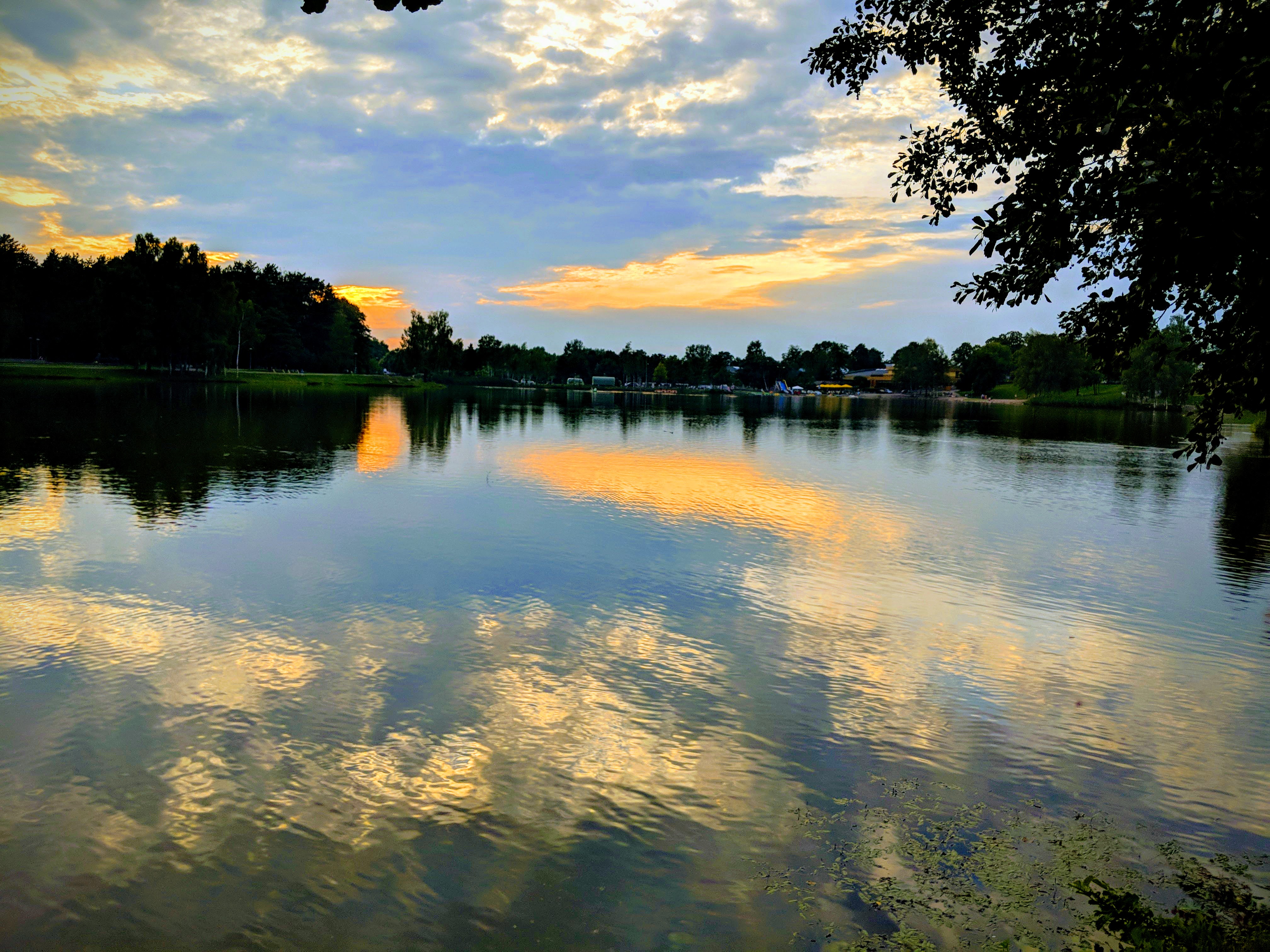 Sunset reflections over a tranquil lake surrounded by trees